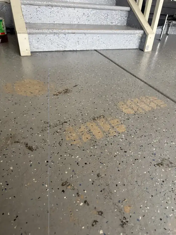 Garage coating pulled up from hot tire damage